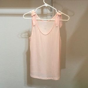 a pink tank top with ties at the shoulder